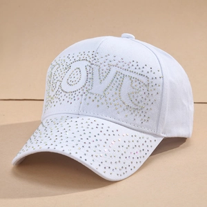 White baseball cap with colorful rhinestones forming LOVE text on a 45-degree angle