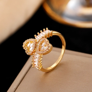 Macro shot of gold heart ring with cubic zirconia stones on luxury jewelry box