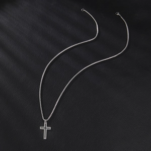 Minimalist silver stainless steel cross pendant necklace on black leather background