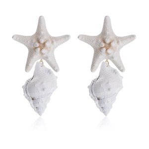 Close-up of handmade white starfish and seashell drop earrings with gold metal links