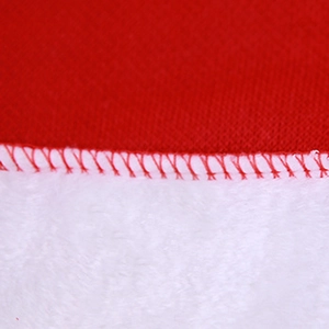 Detailed close-up showing red felt fabric and white plush faux fur seam on a Christmas hat