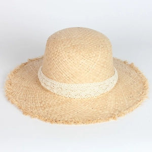 Straw sun hat with white lace trim and frayed edge for summer beach vacation