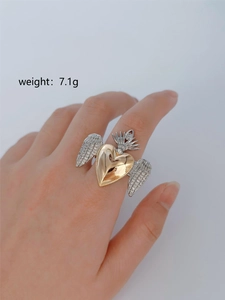 Macro detail of gothic winged heart ring with crown and rhinestones weighing 7.1g