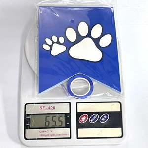 Blue dog paw print bunting flags with ribbon in packaging shown on weight scale