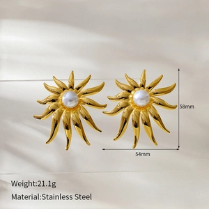 Detailed view of large gold sun earrings with pearl inlay and exact dimensions in mm