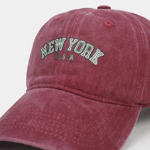 Close-up of vintage burgundy washed cotton baseball cap with New York embroidery