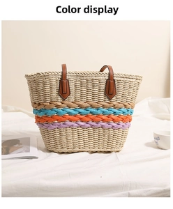 Detail of bohemian straw bag with rainbow stripes and reinforced brown leather handles