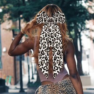 Leopard print bow hair clip worn by model showing the elegant vintage fabric texture