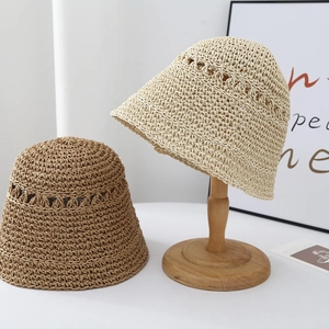 Detailed knit texture of foldable straw sun hats in beige and light brown finishes