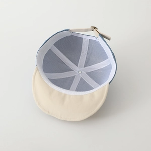 Detailed view of kids baseball cap interior with breathable mesh lining and metal buckle
