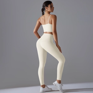 Detail shot of ivory yoga set featuring high waist leggings and thin strap sports bra