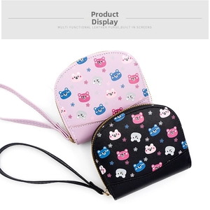 Close-up of compact PU leather coin purse featuring colorful cartoon bear and floral prints
