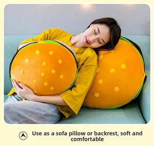 Detail showing plush hamburger pillows in different sizes on a soft fabric sofa