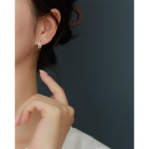 Elegant S925 sterling silver olive leaf hoop earrings with diamonds on a model