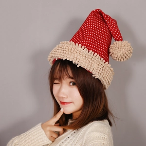 Red knitted Christmas hat with snowflake patterns and plush pompom worn by a model