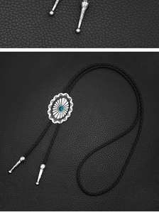Macro detail of Celtic silver bolo tie with turquoise stone and woven leather cord