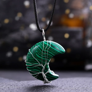 Close-up of malachite moon pendant with silver tree of life wire wrapping detail