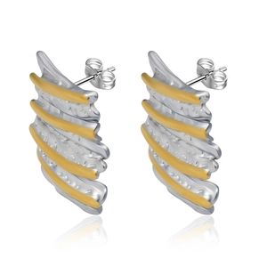 Macro shot of irregular geometric wavy earrings in two-tone gold and silver steel