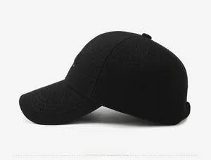 Detailed side view of black winter baseball cap showing textured fabric and curved brim