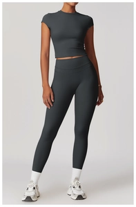 Close-up of high-waisted dark grey yoga leggings and matching short sleeve crop top