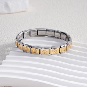 Detail of Italian charm bracelet links featuring gold floral pattern and stainless steel mark