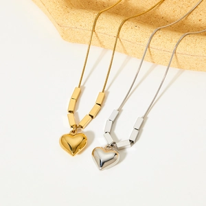 Elegant gold and silver heart cube necklaces with sleek snake chain and metallic luster