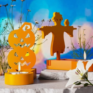 Halloween pumpkin and scarecrow candle holders on white rock base with tea lights