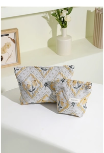 Close-up of vintage floral jacquard makeup bag set with premium brand label and metal zipper