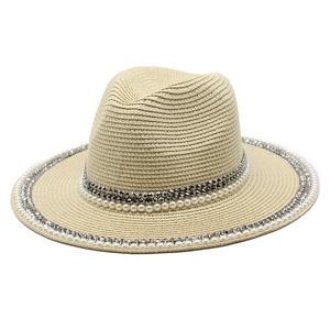 Close-up of beige straw fedora hat featuring elegant white pearl and silver stud band