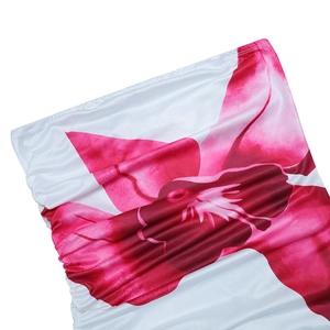 Detail of white strapless dress with magenta floral pattern and elegant ruched fabric
