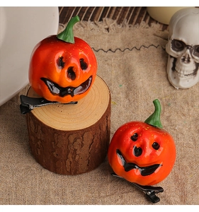 Detail of creative orange pumpkin hair clips with smiling faces for Halloween party decor