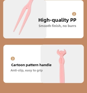 Detail of pink plastic fruit fork showing double-prong tip and anti-slip cartoon handle