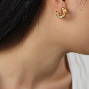 Elegant gold-plated U-shaped earrings with colorful crystals on female model