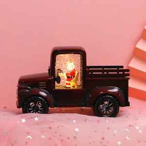 Detail of red vintage Christmas truck lantern with Santa figure and glowing LED light