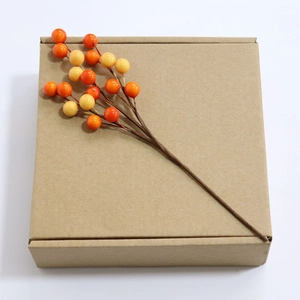 Brown kraft paper gift box decorated with realistic orange berries for festive packaging