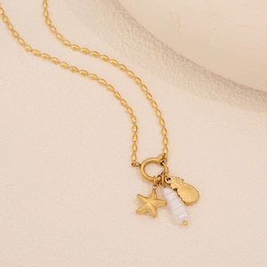 Detail of gold necklace with detachable starfish, pineapple and white pearl bead pendants