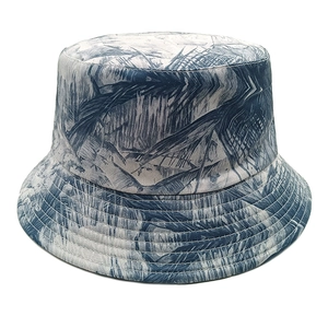 Reversible bucket hat with blue tropical leaf print and reinforced stitched brim design