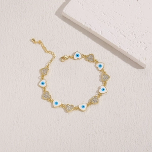 Detail of 14K gold plated heart bracelet with evil eye enamel and white zircon stones