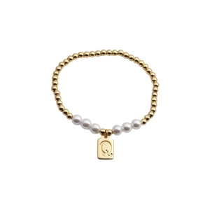 Detail view of a gold bead bracelet with white pearls and square Q letter pendant charm