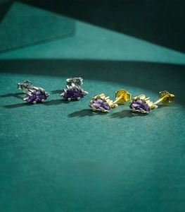 Detail of S925 sterling silver hallmark on purple crystal dinosaur stud earrings