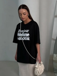 Detail of black cotton oversized T-shirt with white Bonjour Madame lettering print