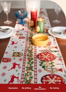 Detail of Christmas table runner with jacquard reindeer and snowflake patterns