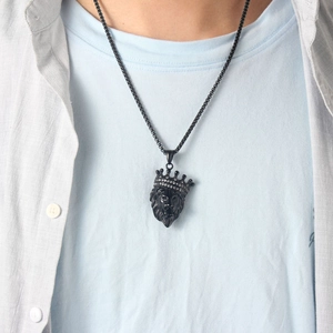 Hip hop black lion head pendant with crown and diamonds worn by a male model