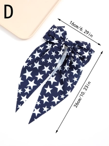 Detail view of navy blue star bow hair clip with dimensions 16cm x 26cm for Independence Day