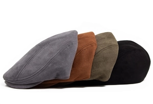 Detailed stack of vintage faux suede flat caps in grey, brown, green and black colors