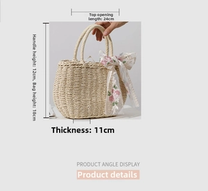 Detail showing straw woven bag dimensions 24x18x11cm with floral lace bow detail