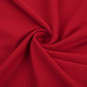 Detailed view of red knitted fabric texture with elegant twisted knot and fishtail drape