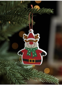 Close-up of wooden reindeer ornament hanging on a Christmas tree with warm bokeh light