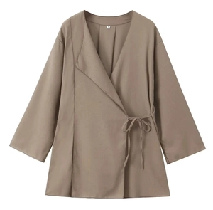 Detail view of khaki linen wrap top featuring side-tie design and inner size S label
