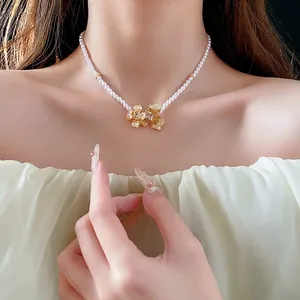 Elegant gold plated flower pendant pearl necklace on model showing luxury style